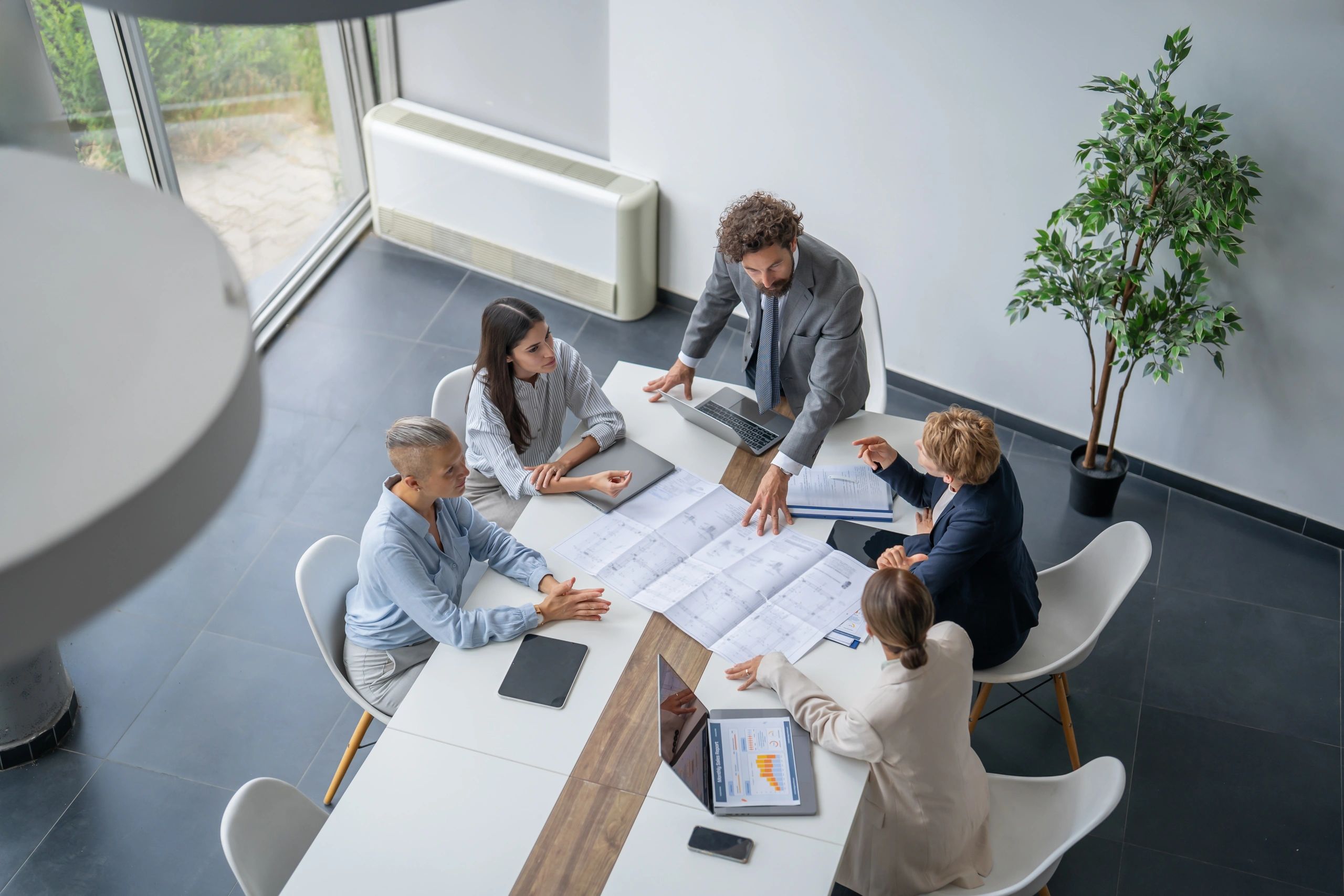 Team reviewing blueprints during a planning meeting