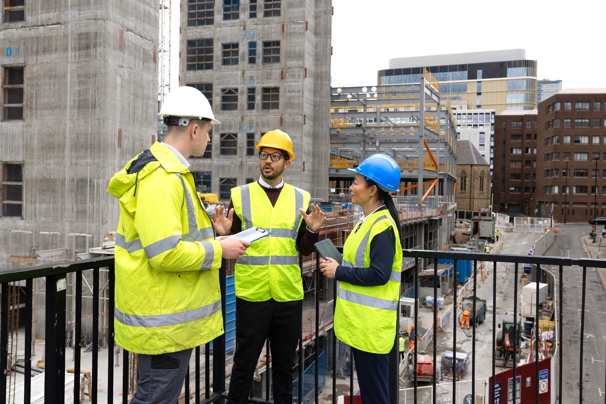 Construction team reviewing plans at an active job site
