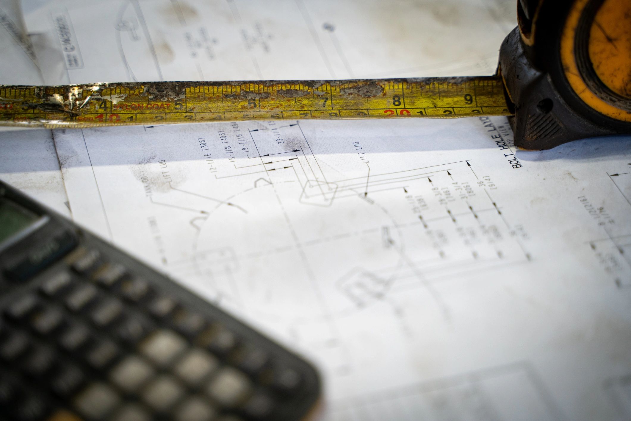 Calculator and blueprint used for precise site measurement
